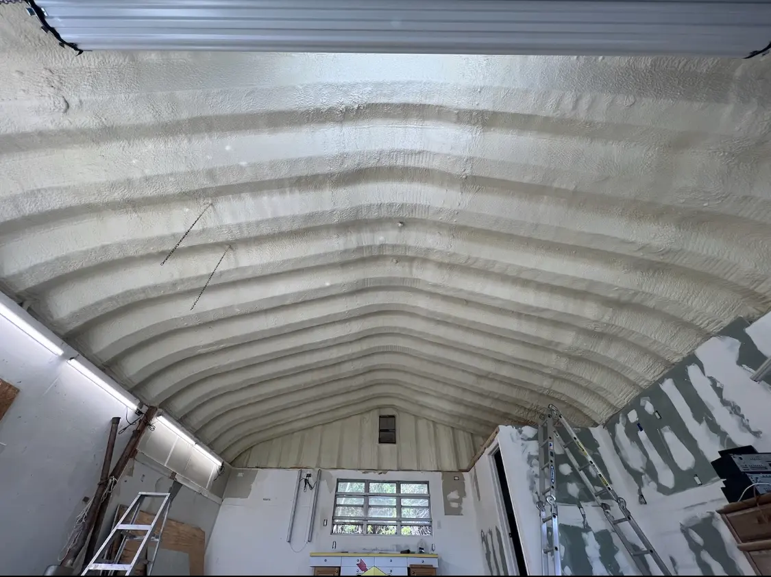 Spray polyurethane foam applied to the underside of a metal roof deck in Johnstown